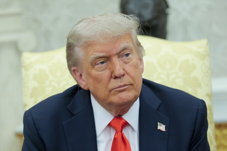 Donald Trump sits in the Oval Office of the White House.