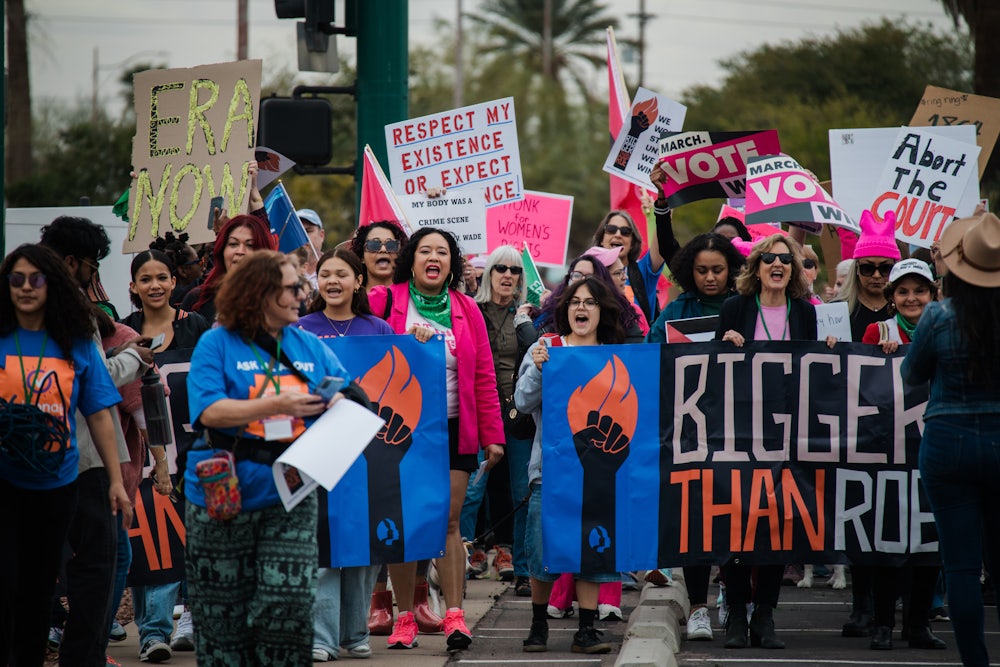 Demonstrators hold pro-choice signs.
