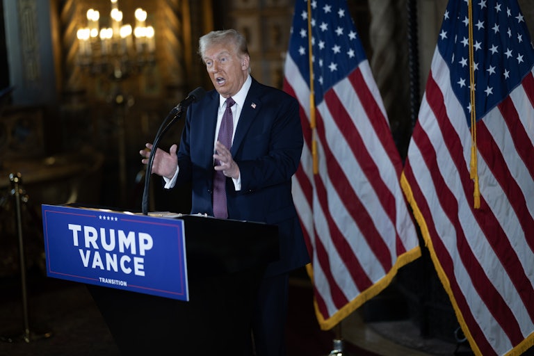 Donald Trump gestures while speaking at a podium