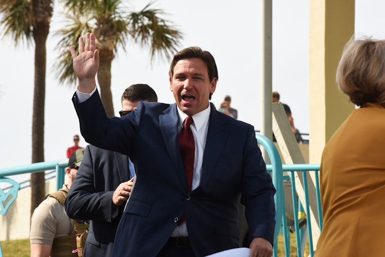 Ron DeSantis waves and has his mouth open