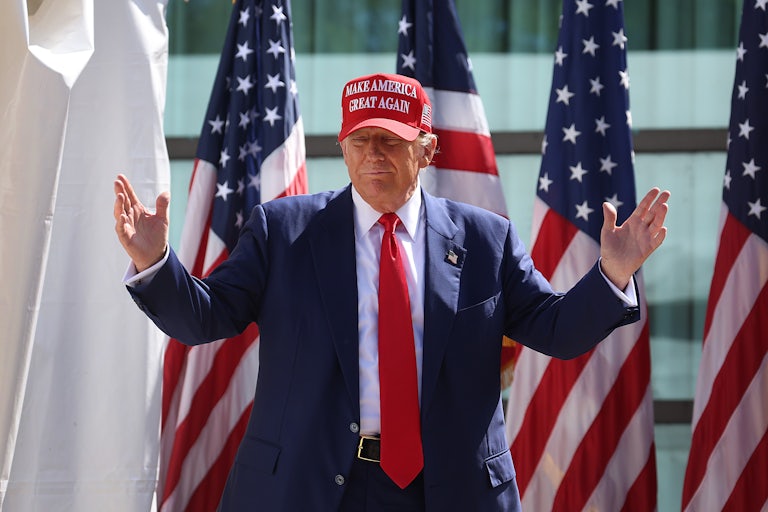 Donald Trump holds up his hands