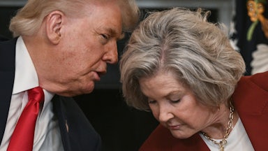 Donald Trump leans over to whisper something to Susie Wiles