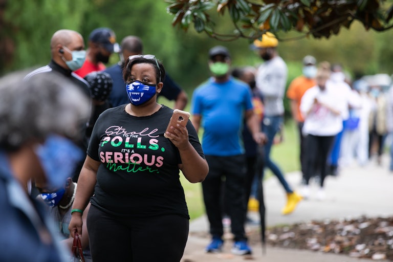 A woman wearing a mask in line for early voting in Atlanta.