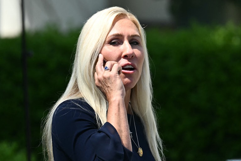 Representative Marjorie Taylor Greene speaks on her phone