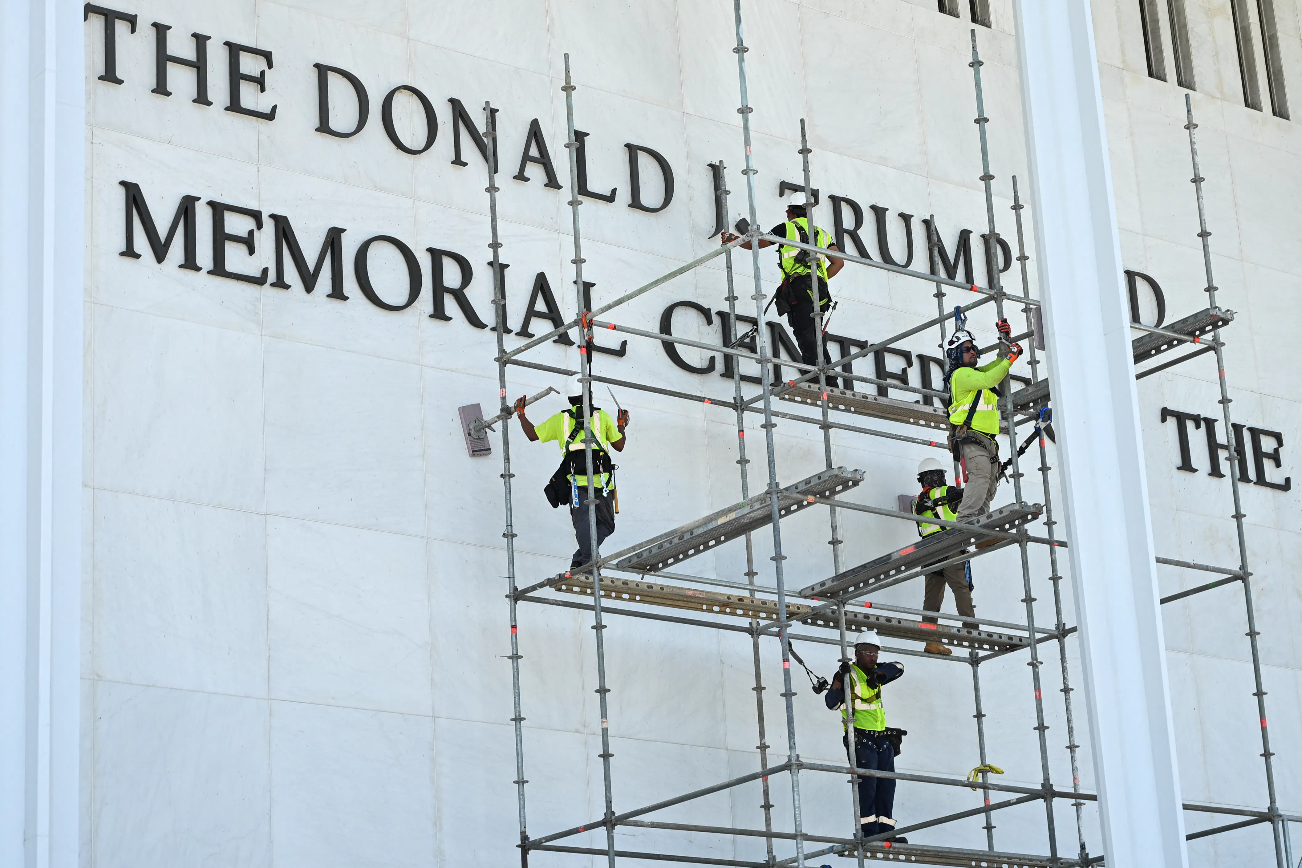 Workers remove Donald Trump’s name from the Kennedy Center on June 12. 