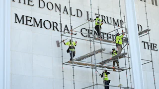 Workers remove Donald Trump’s name from the Kennedy Center on June 12.