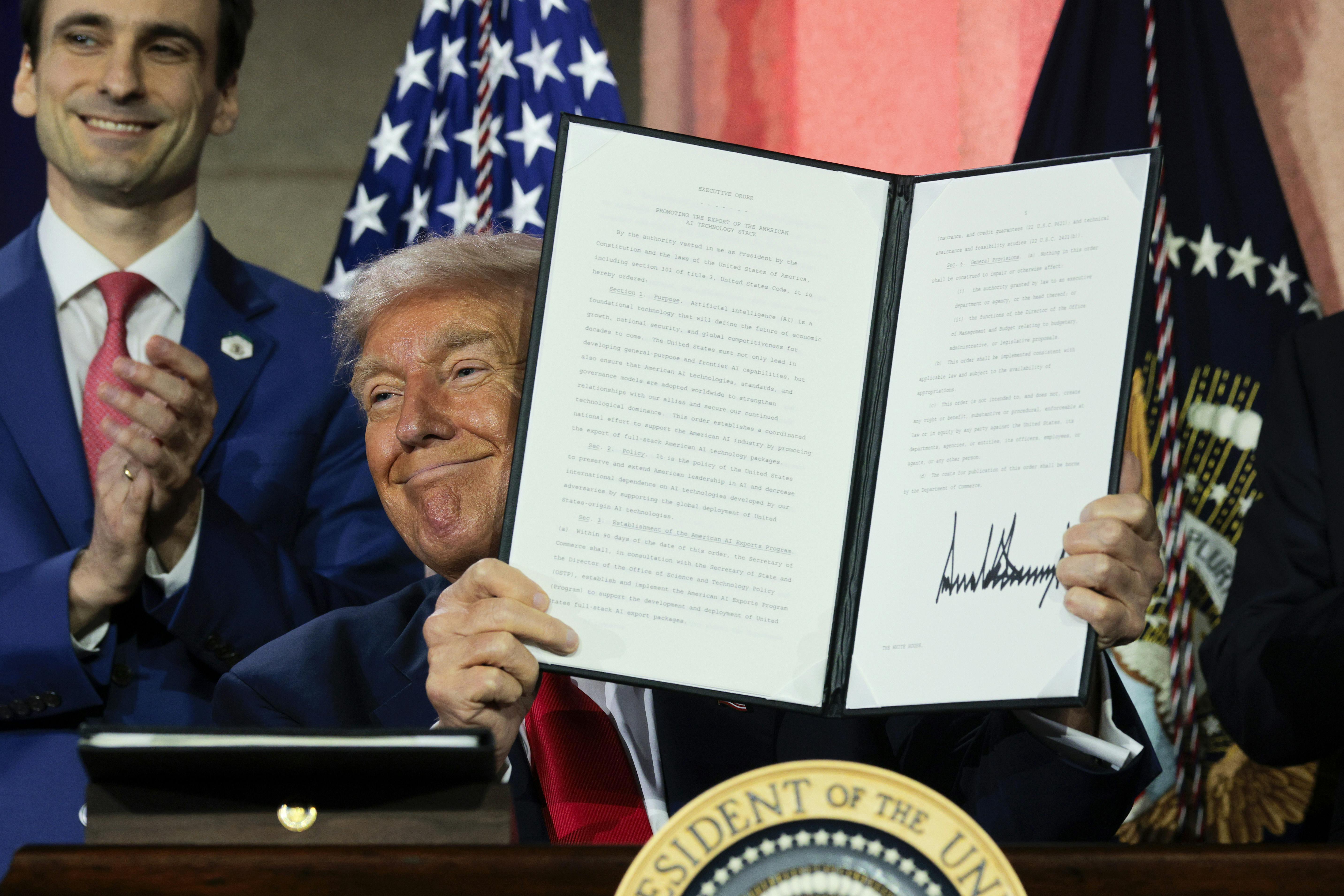 President Donald Trump displays a signed executive order during the “Winning the AI Race” summit hosted by All‑In Podcast and Hill & Valley Forum at the Andrew W. Mellon Auditorium on July 23, 2025 in Washington, D.C. Trump signed executive orders related to his Artificial Intelligence Action Plan during the event. 