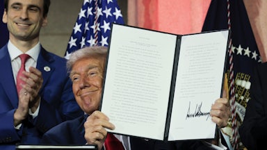 President Donald Trump displays a signed executive order during the “Winning the AI Race” summit hosted by All‑In Podcast and Hill & Valley Forum at the Andrew W. Mellon Auditorium on July 23, 2025 in Washington, D.C. Trump signed executive orders related to his Artificial Intelligence Action Plan during the event.