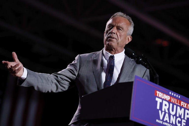 Robert F. Kennedy Jr. gestures while standing at a podium during a Donald Trump event