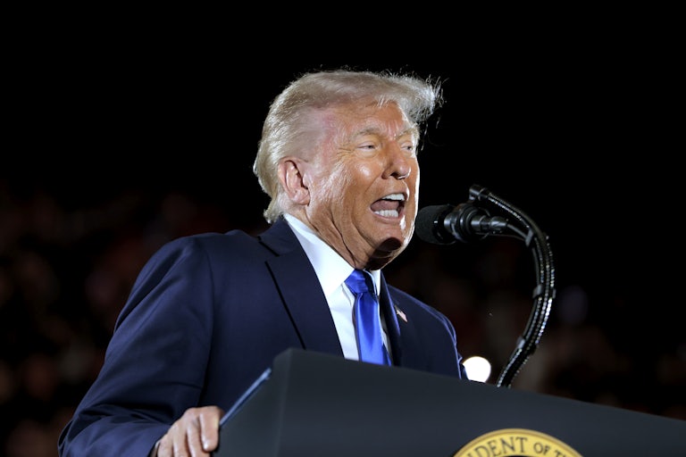 Donald Trump yells wildly at a lectern.