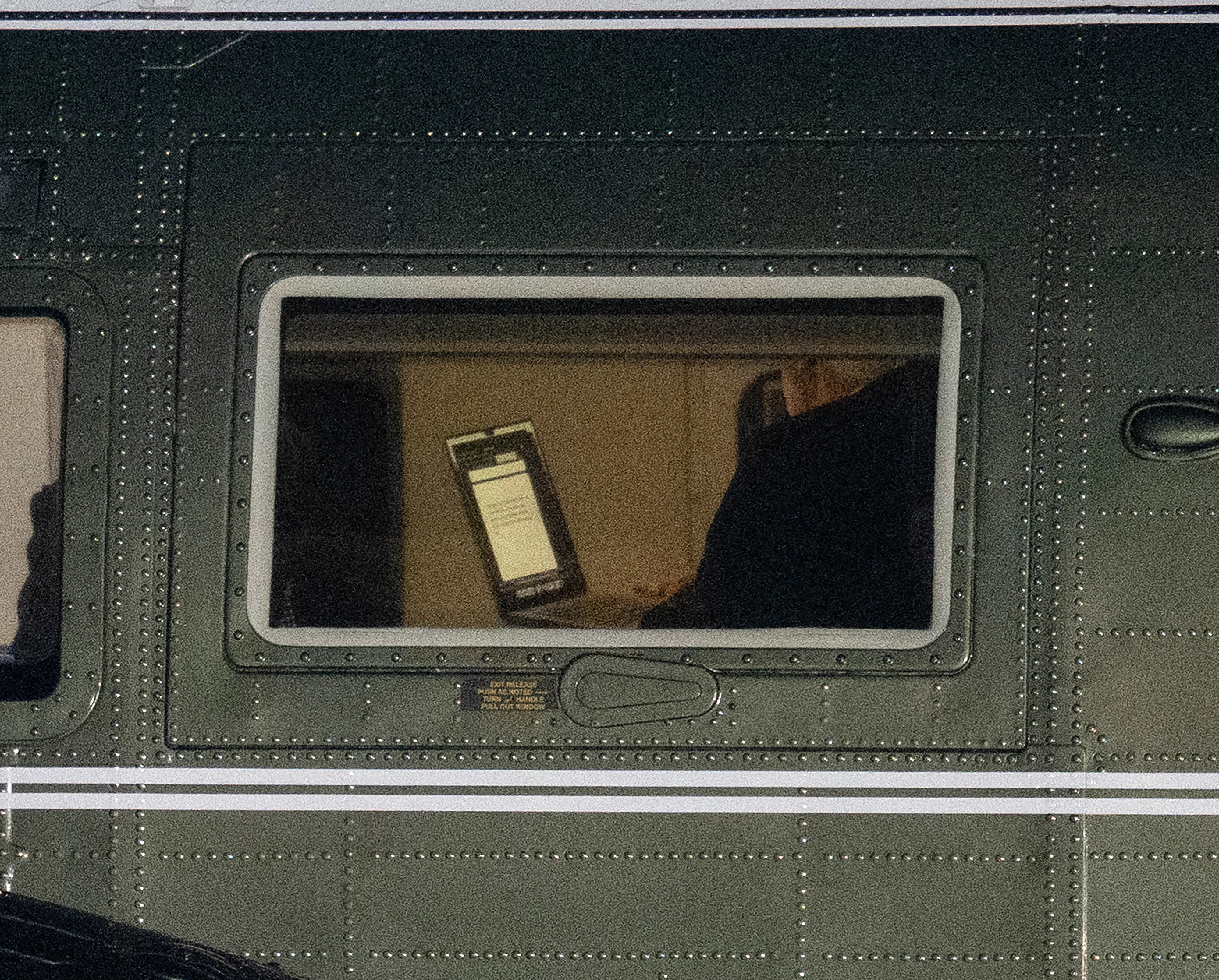 President Donald Trump holds a laptop aboard Marine One