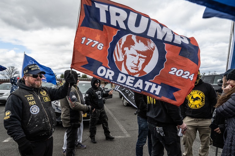 Proud Boys wave a Donald Trump flag