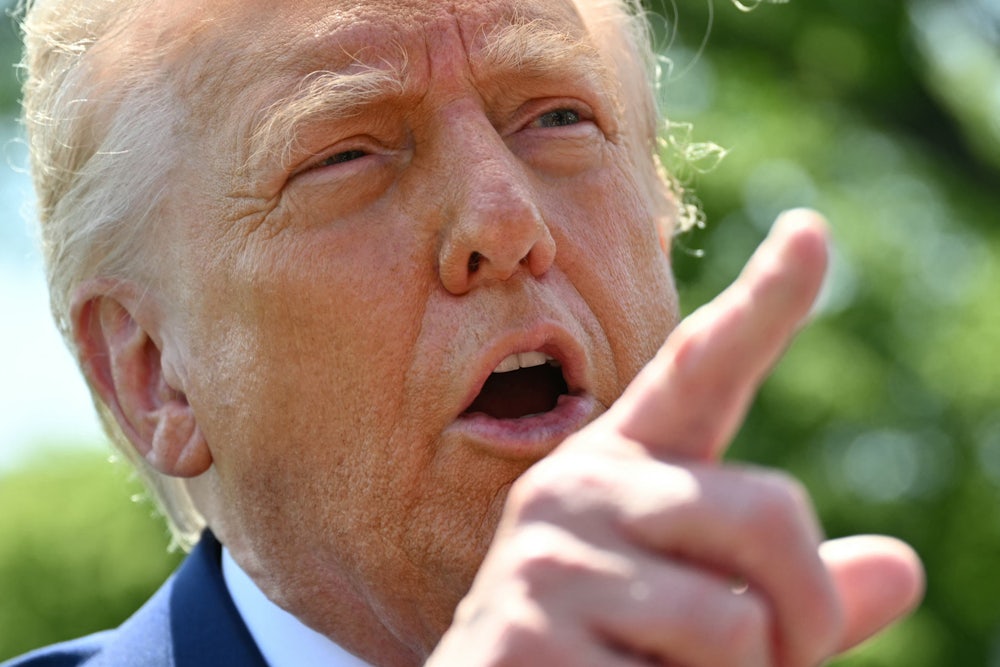 Donald Trump speaks to the media as he walks to board Marine One at the White House in Washington, D.C.