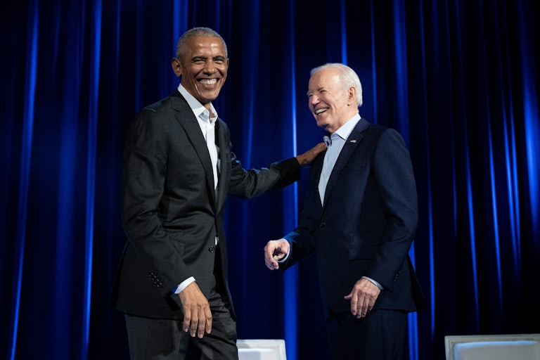 Obama puts his hand on Biden's shoulder as both laugh