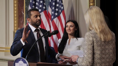 Kash Patel swears in as FBI director while his girlfriend Alexis Wilkins smiles and looks on.