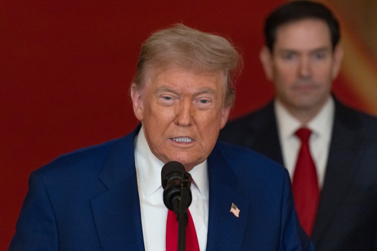 Donald Trump speaks while Secretary of State Marco Rubio stands behind him.