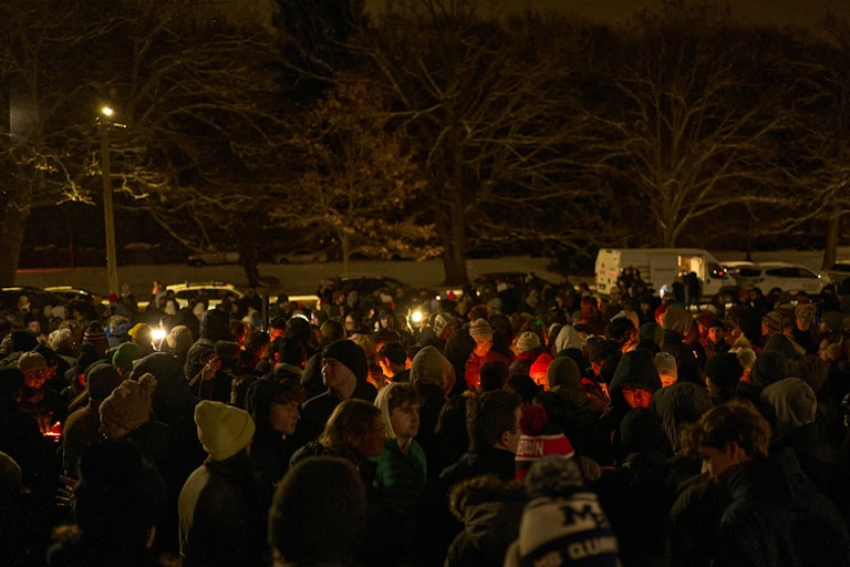 People participate in a vigil at Brown University