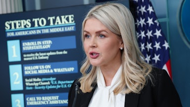 White House press secretary Karoline Leavitt stands in front of a screen that says "Steps to Take for Americans in the Middle East."