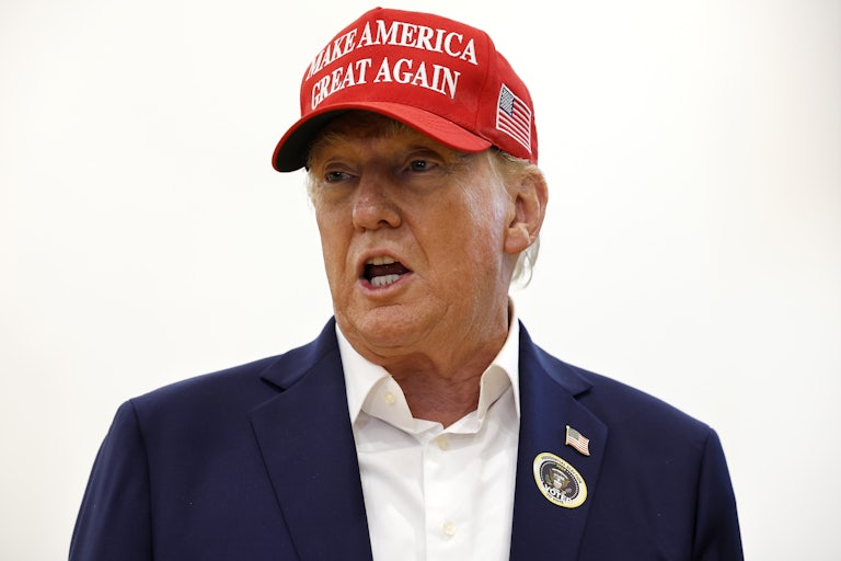 Donald Trump speaks while wearing a Make America Great Again hat