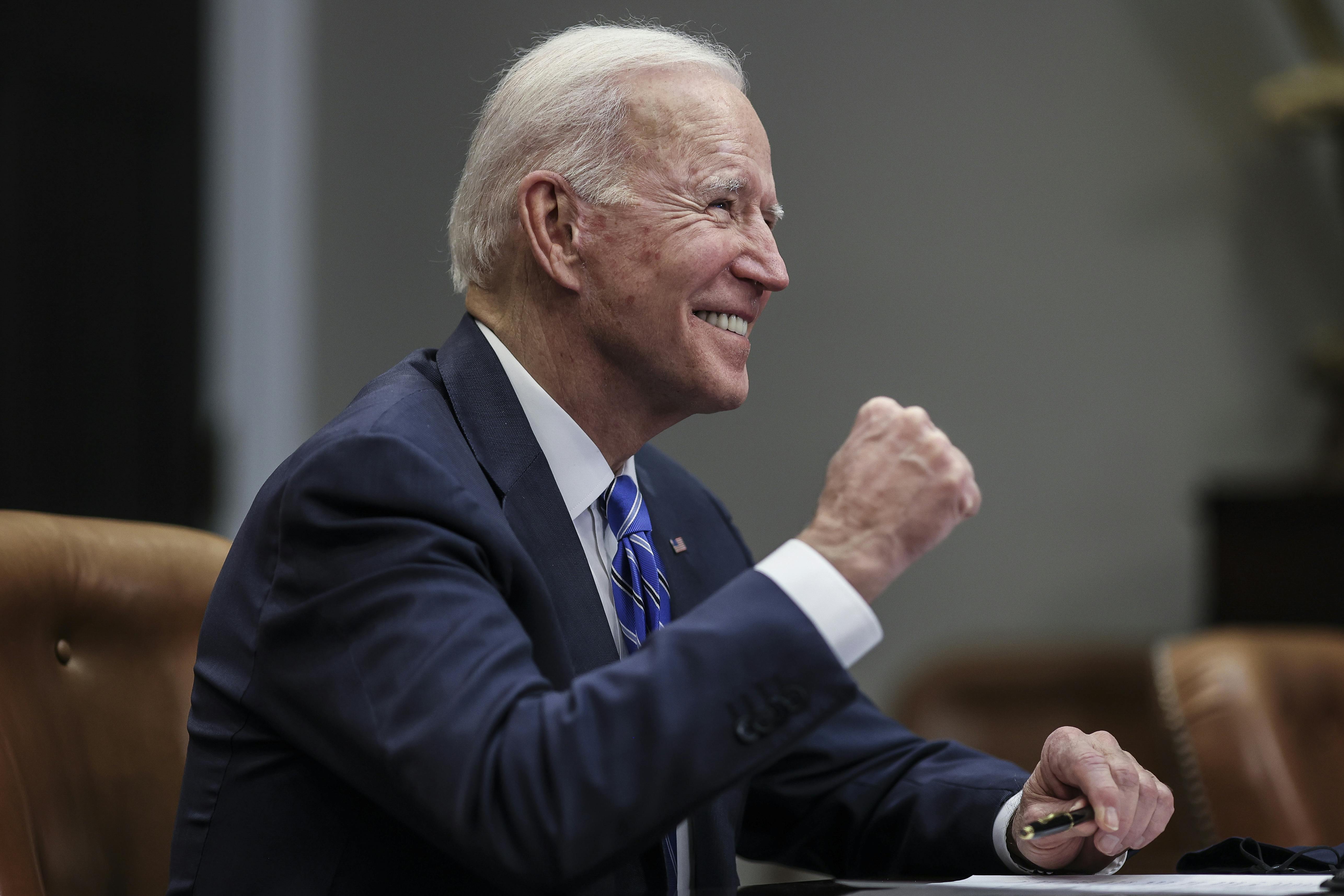 President Joe Biden celebrates with a fist pump at the White House.