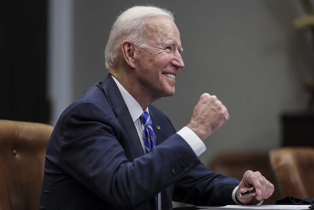 President Joe Biden celebrates with a fist pump at the White House.