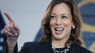 Kamala Harris smiles and points a finger