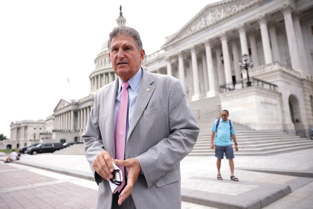 West Virginia Senator Joe Manchin stands on the steps of the U.S. Capitol.