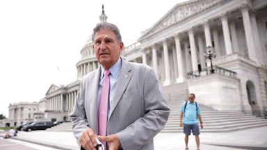 West Virginia Senator Joe Manchin stands on the steps of the U.S. Capitol.