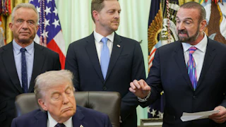 President and Chief Scientific Officer of Regeneron Pharmaceuticals George Yancopoulos speaks alongside Health Secretary Robert F. Kennedy Jr., Director of the Center for Medicare Chris Klomp, and Donald Trump during a White House event on health care affordability in the Oval Office. Trump's eyes are closed.
