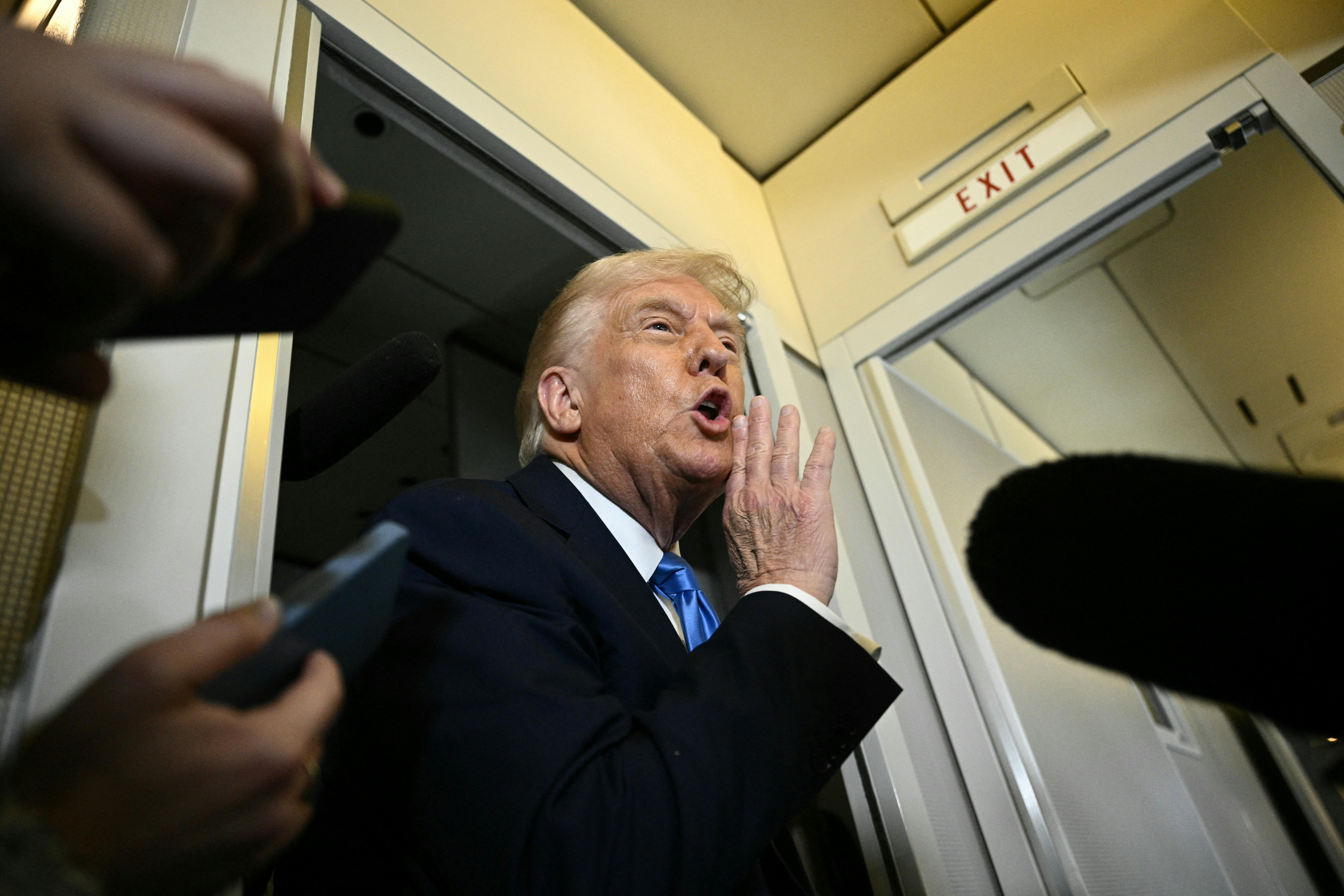 Donald Trump speaks to the press aboard Air Force One.