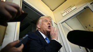 Donald Trump speaks to the press aboard Air Force One.