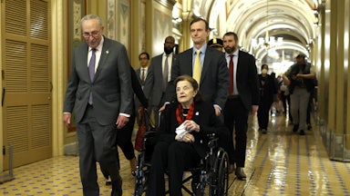 Senate Majority Leader Charles Schumer escorts Senator Dianne Feinstein