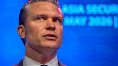 Secretary Pete Hegseth looks to the side