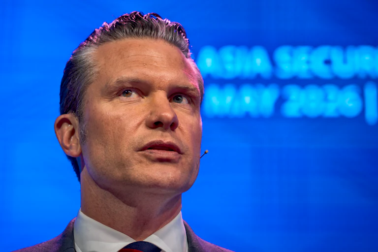Secretary Pete Hegseth looks to the side