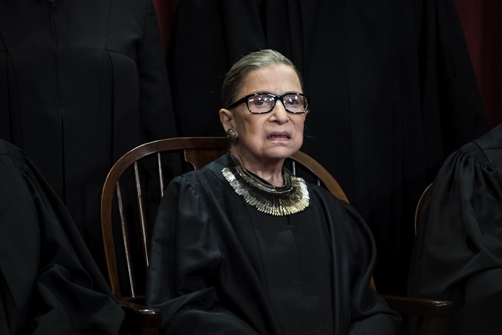 A close-up of Justice Ruth Bader Ginsburg, posing for her official Supreme Court portrait.
