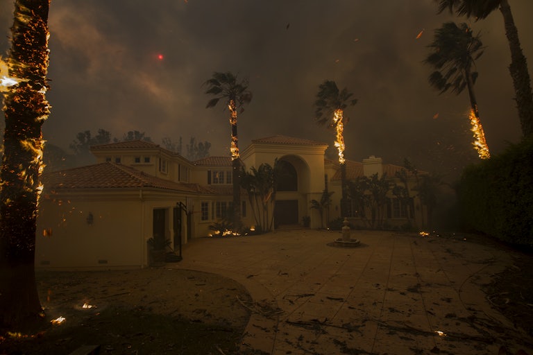 wildfire burns near a house in Malibu California