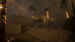 wildfire burns near a house in Malibu California