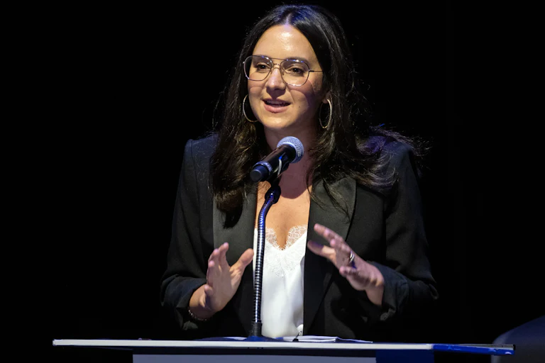 Bari Weiss speaks at a podium