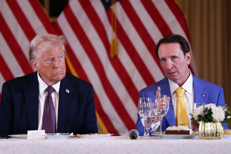 Louisiana Governor Jeff Landry gestures and speaks while sitting next to Donald Trump