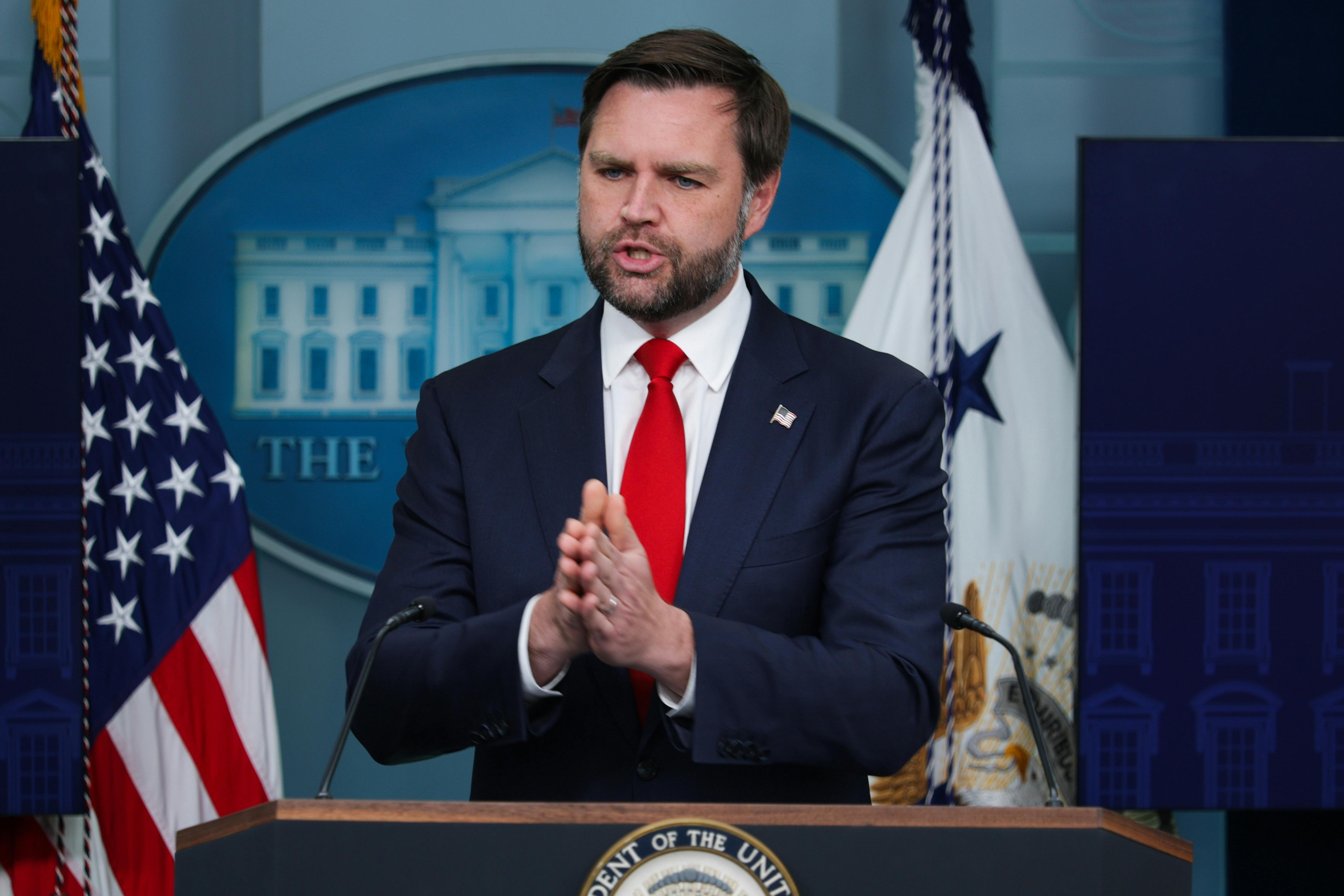 JD Vance speaks at the podium in the White House press briefing room.