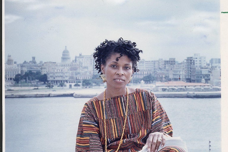 JoAnn Chesimard, aka Assata Shakur, holds the manuscript of her autobiography with Old Havana, Cuba, in the background on October 7, 1987.
