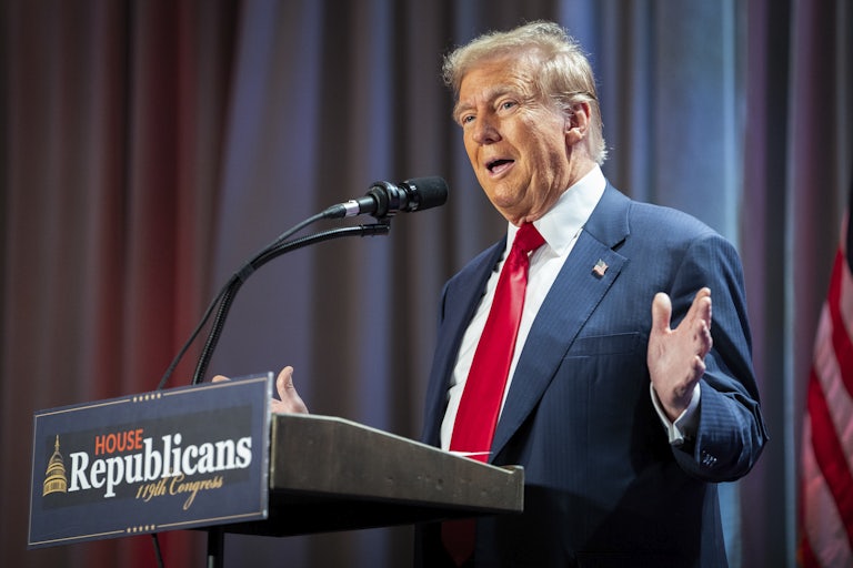 Donald Trump gestures while speaking to the House Republican Caucus