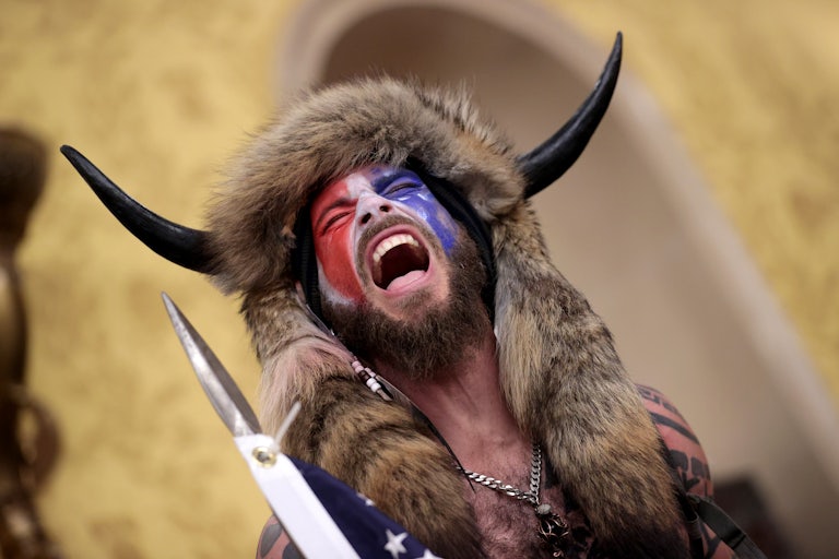 January 6 rioter Jacob Chansley, the self-described “QAnon shaman,” yells while inside the Capitol