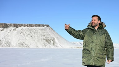 JD Vance waves while wearing a giant coat on his trip to Greenland.