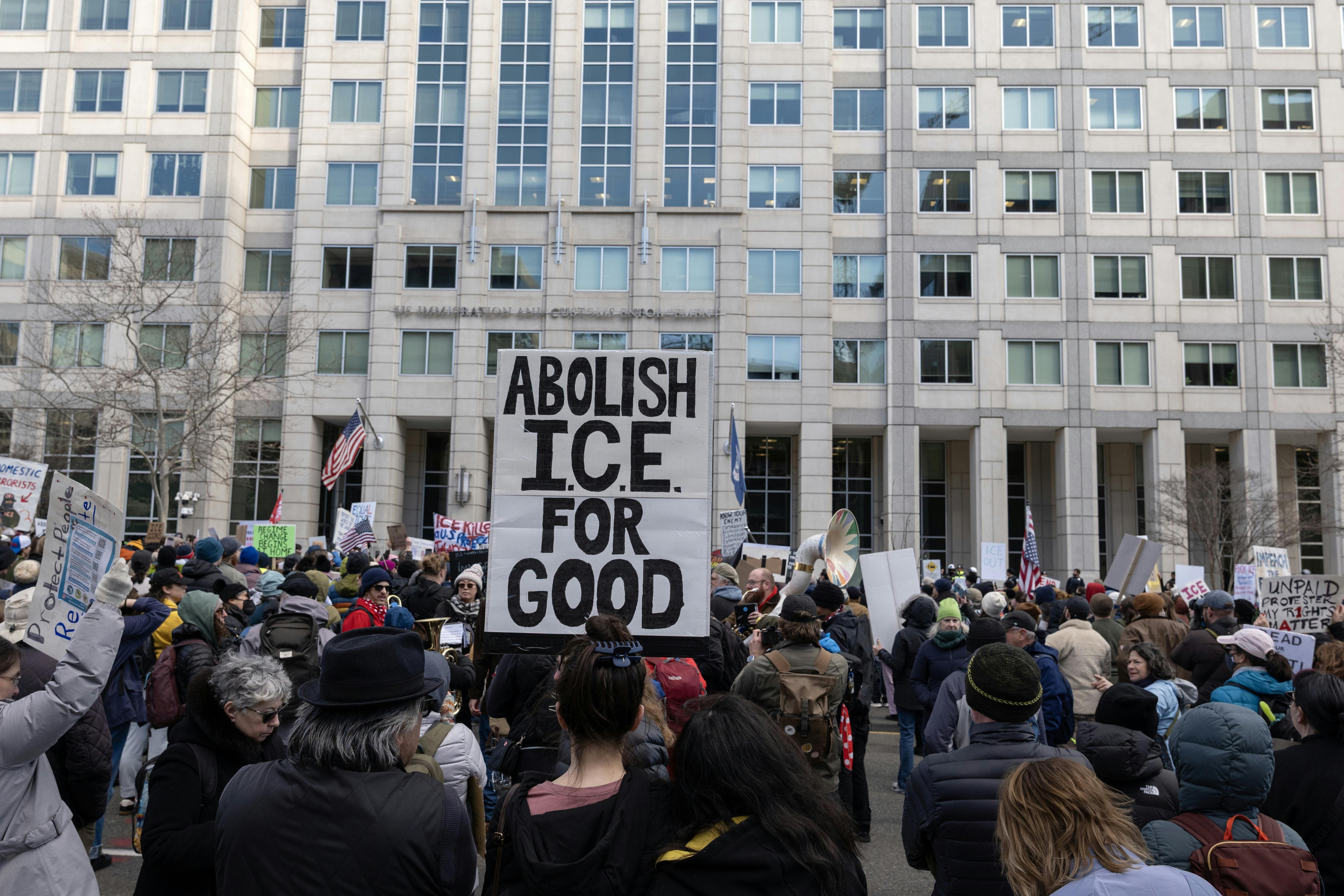 An activist holds a sign reading “Abolish ICE for Good” during a march to the headquarters of U.S. Immigration and Customs Enforcement in Washington, D.C. 