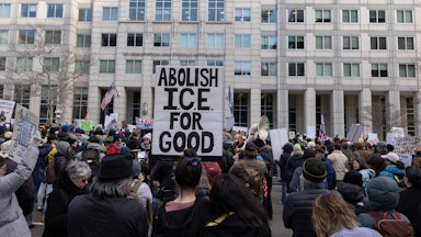 An activist holds a sign reading “Abolish ICE for Good” during a march to the headquarters of U.S. Immigration and Customs Enforcement in Washington, D.C.