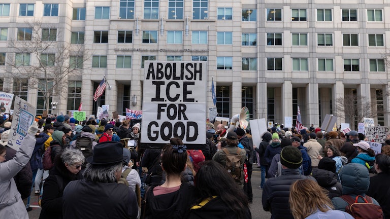 An activist holds a sign reading “Abolish ICE for Good” during a march to the headquarters of U.S. Immigration and Customs Enforcement in Washington, D.C.