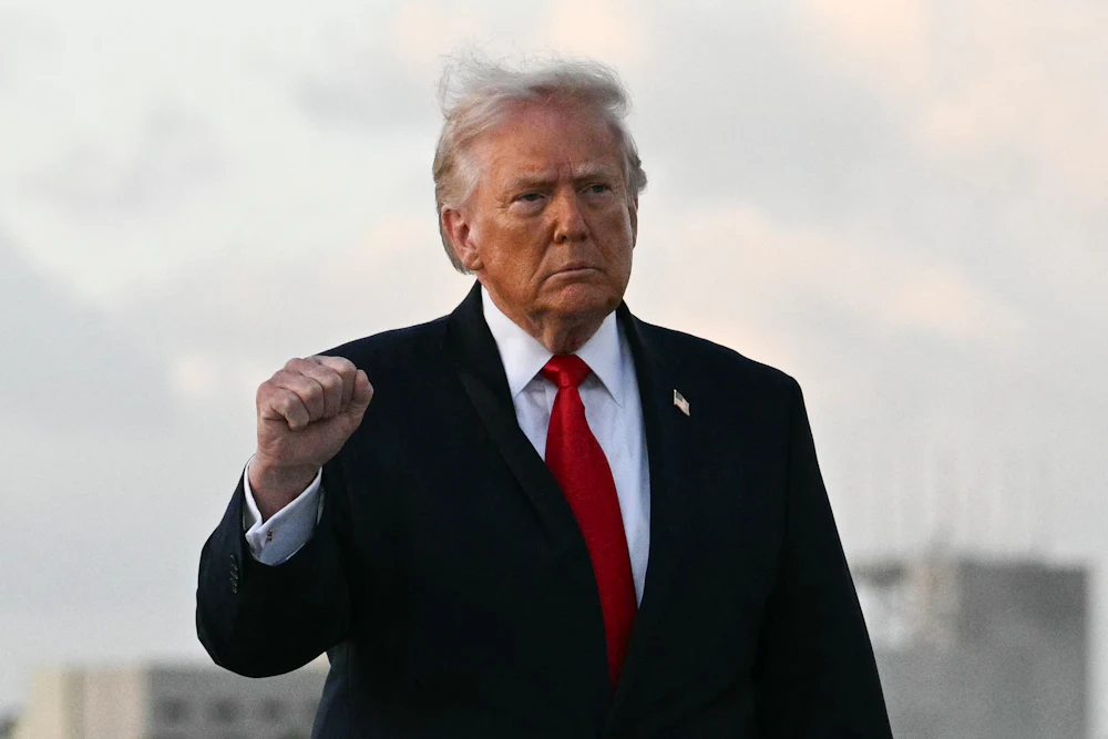 Donald Trump holds up his right hand with a clenched fist