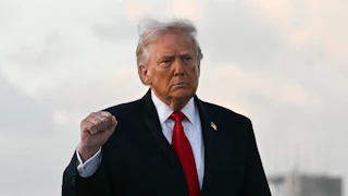 Donald Trump holds up right hand as clenched fist