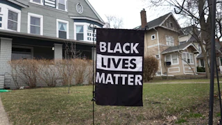 Black Lives Matter sign in someone's front lawn